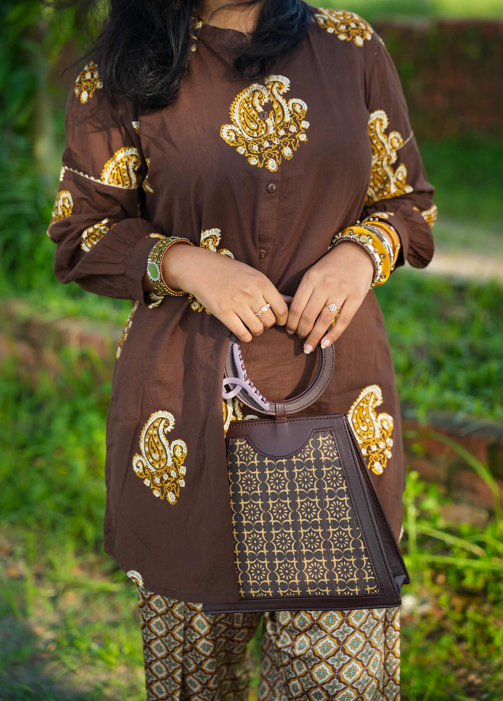 Milind from the front: paisley print, button front, mid-thigh length