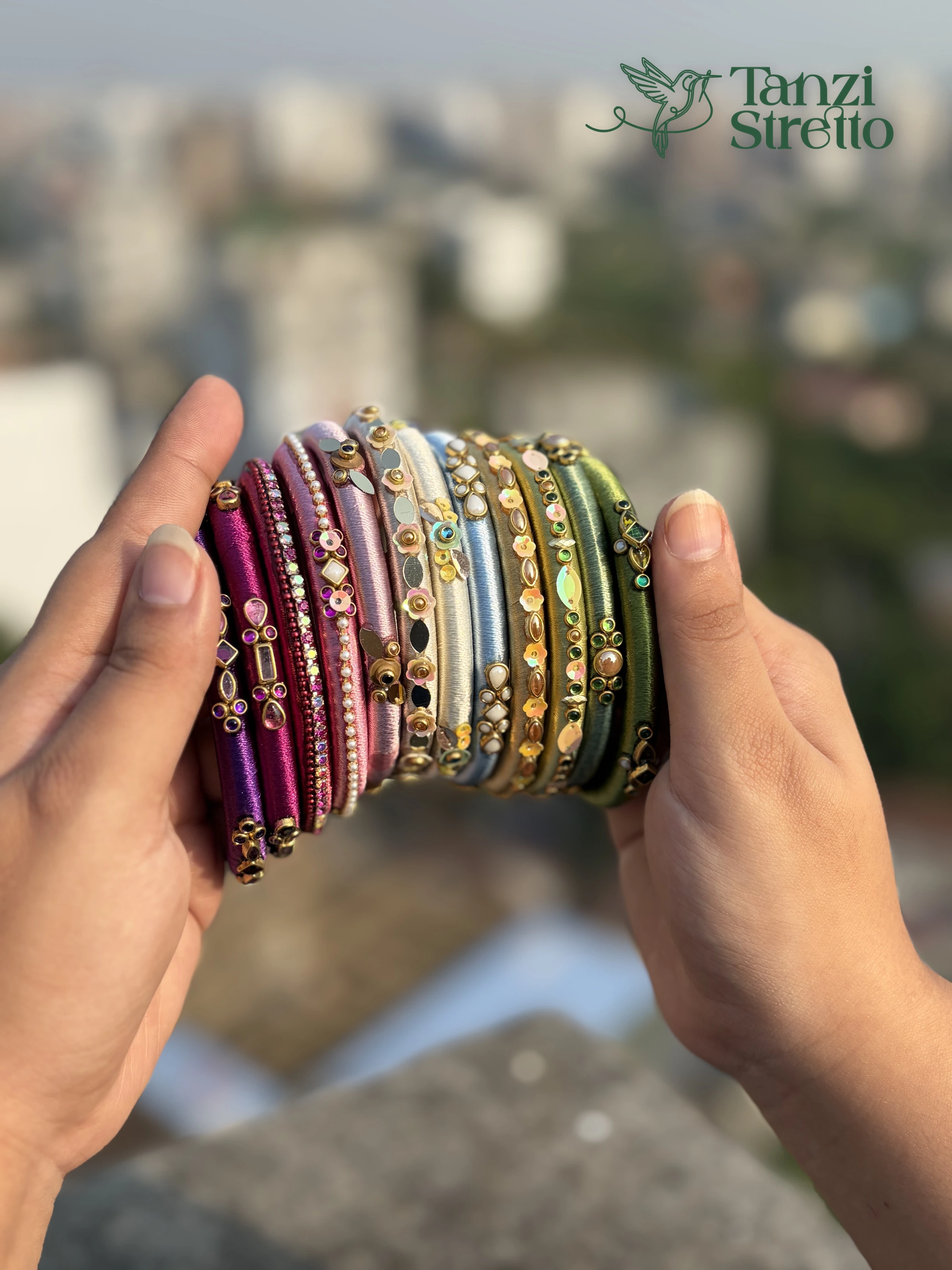 Jolchhap bangles held in both hands, the stones and sequins up close