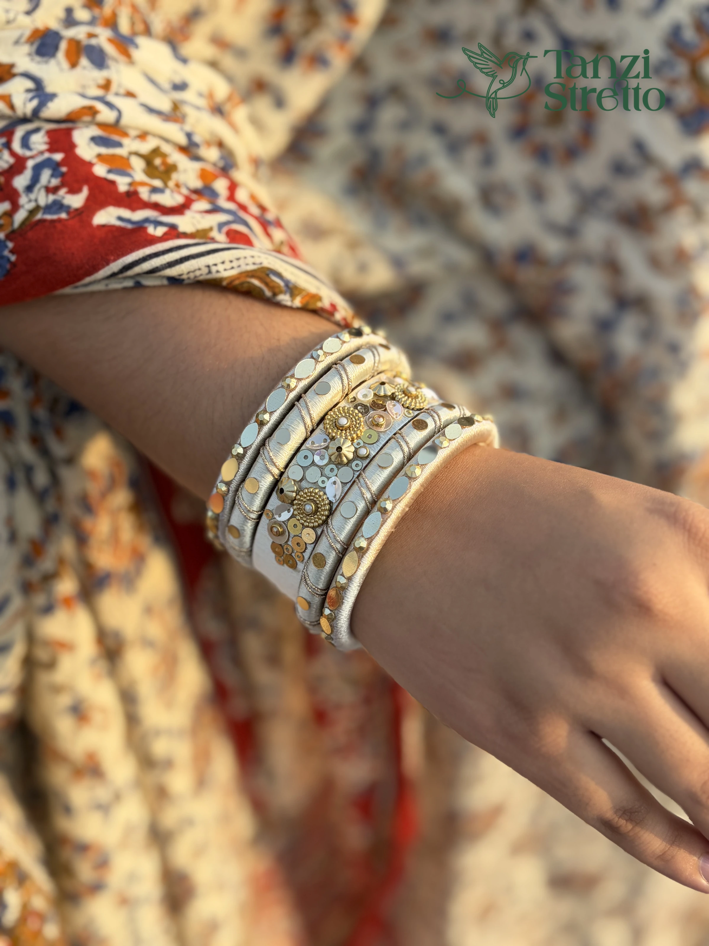 Pankouri 2.0 bangles up close, gold flower studs and silver sequins