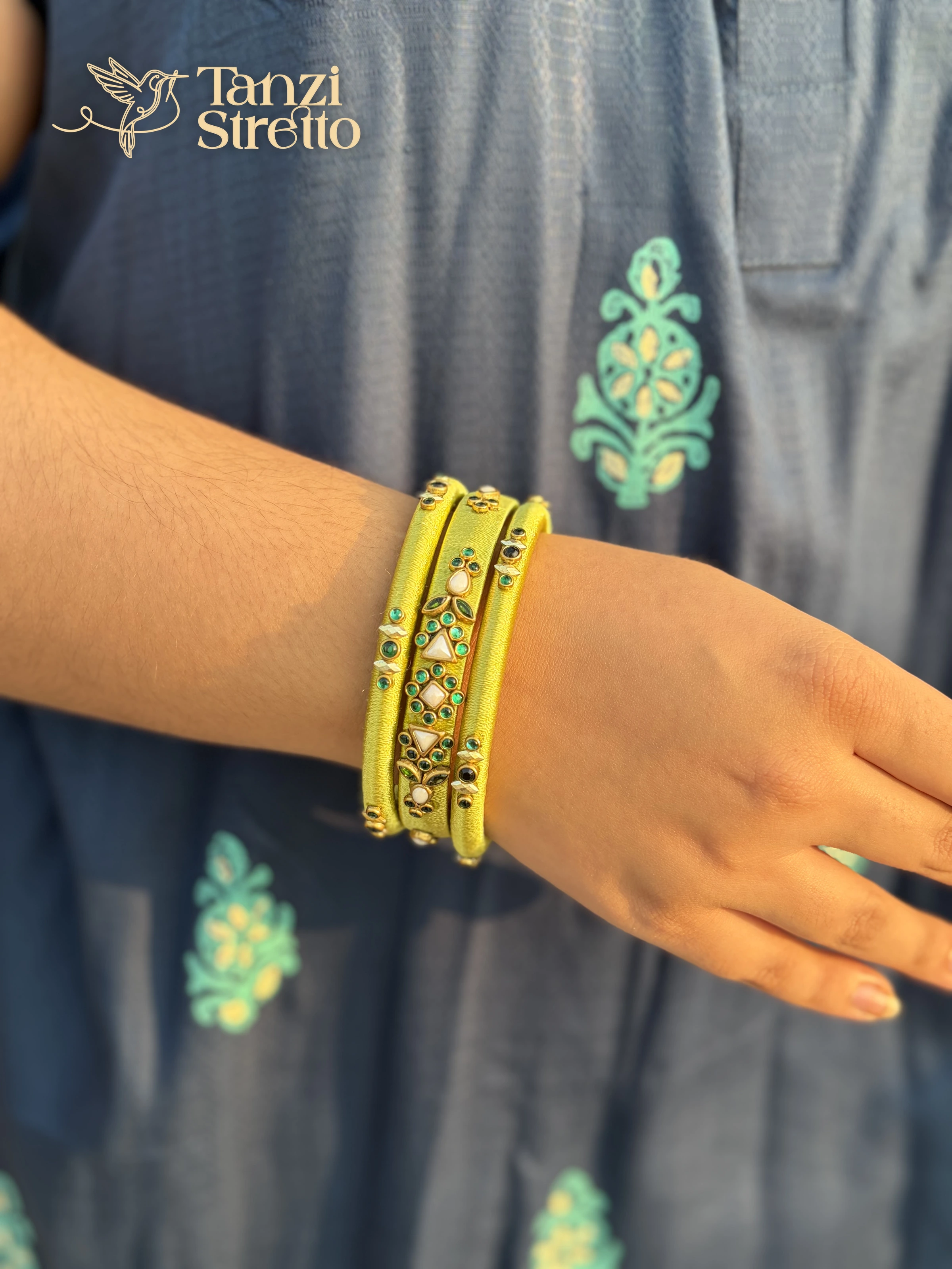 Moyurakkhi set of lime bangles on a relaxed hand