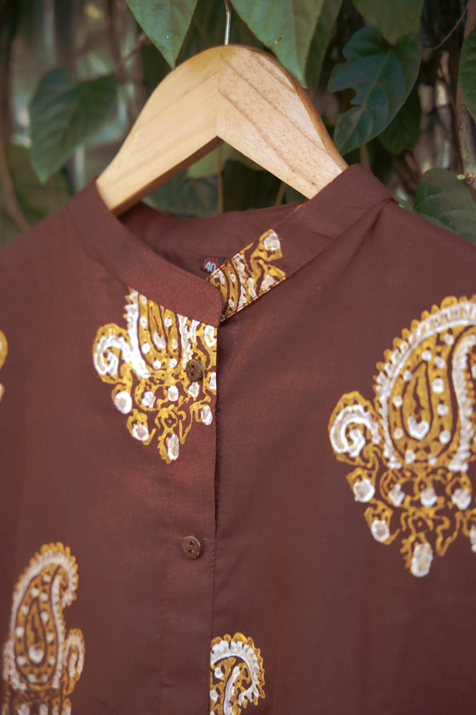 Close-up of the band collar with a mustard and cream paisley below it